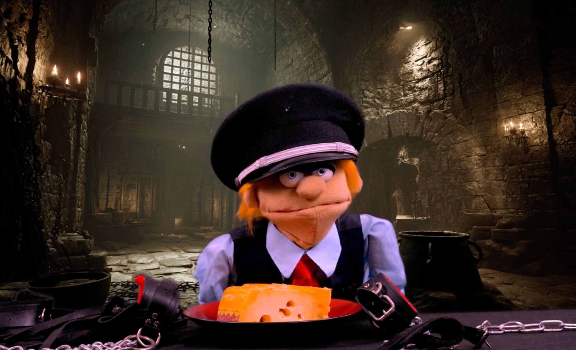 A puppet with a military hat in a dungeon with a piece of cheese that has chained cuffs tying it down.
