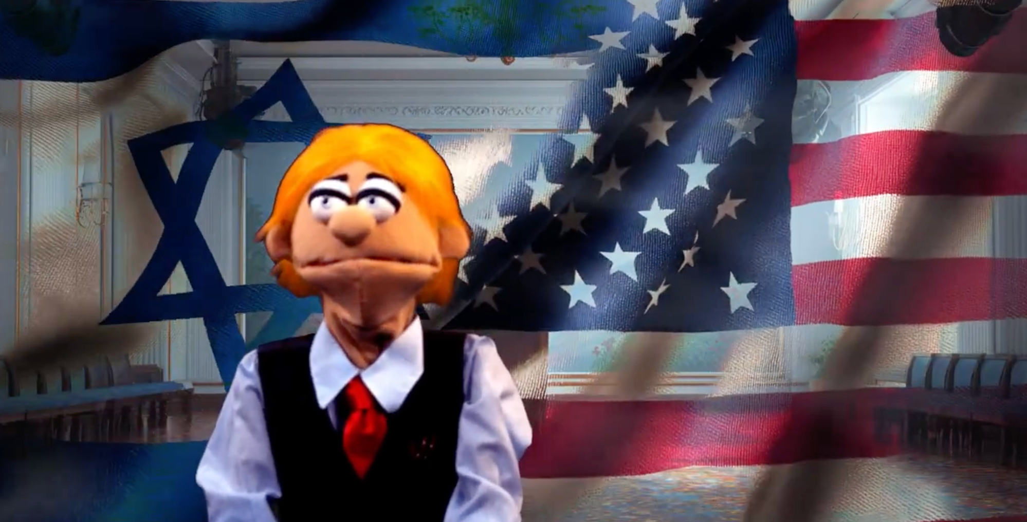 A puppet wearing a tie stands in front of a half flag of America and Israel having a press conference.