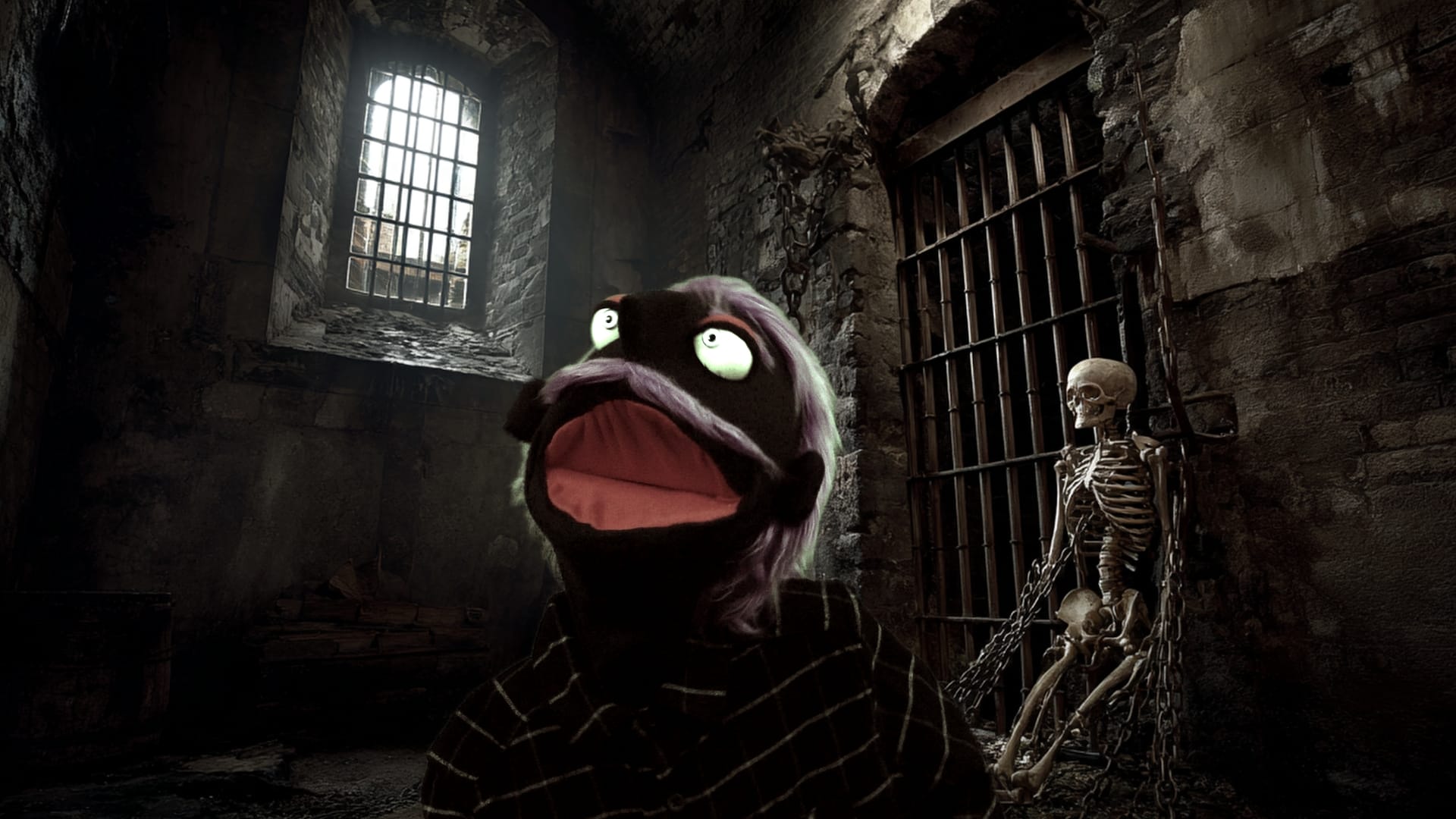 A puppet screams in a dungeon with a skeleton behind him.